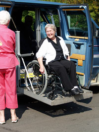 Senior woman on van lift